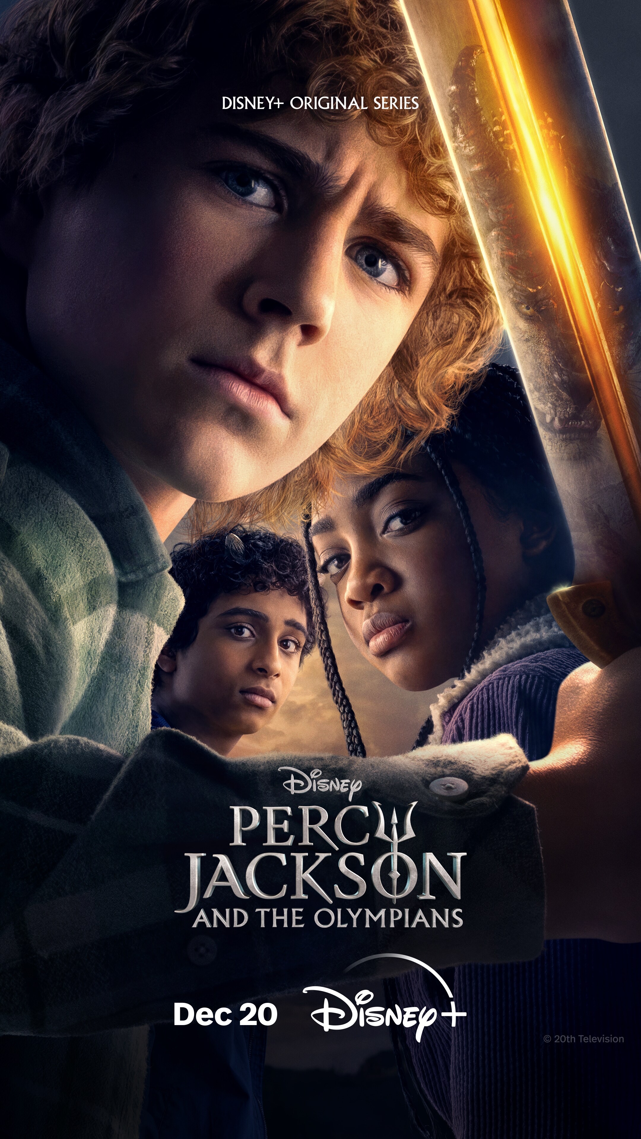 Promotional poster dated December 20 for Percy Jackson and the Olympians, the Disney tv series, depicts a close-up of Percy Jackson holding a sword. Annabeth Chase and Grover Underwood are behind him with the same serious expression.